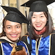 Image of two graduates in graduation wear